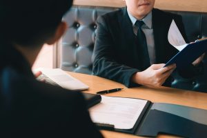 Confident caucasian manager interviews talking with a client prospective male employee.